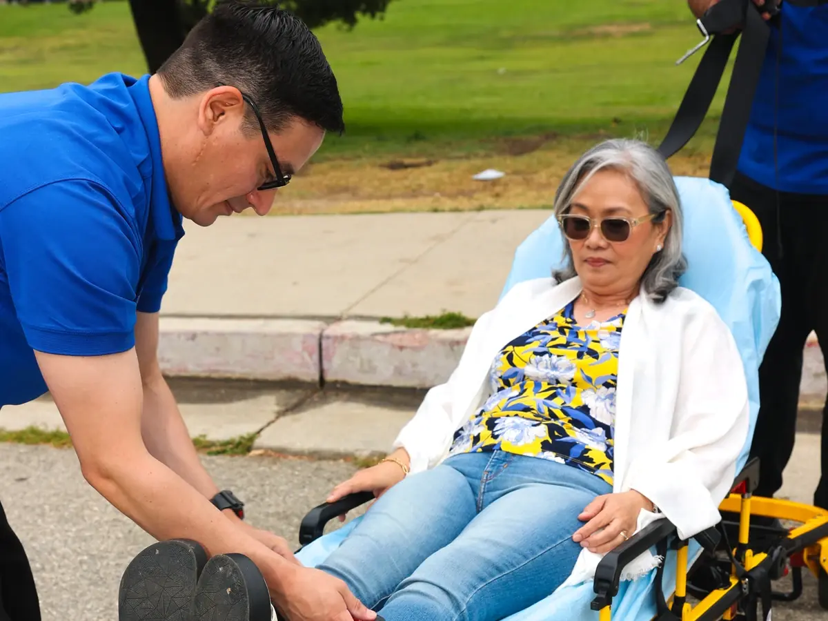 MoveMe Medical team members assisting a rider on a Stryker gurney