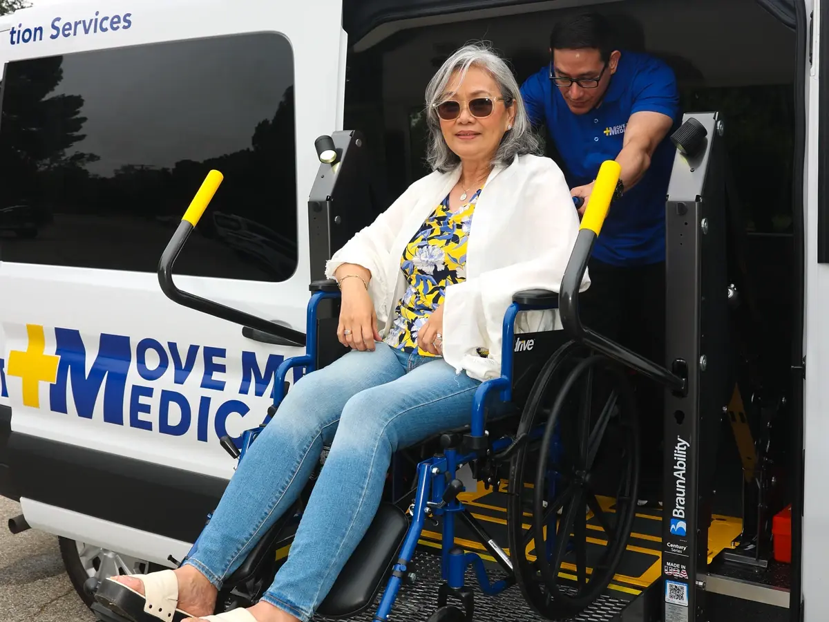 A rider boarding a MoveMe Medical van on the wheelchair lift